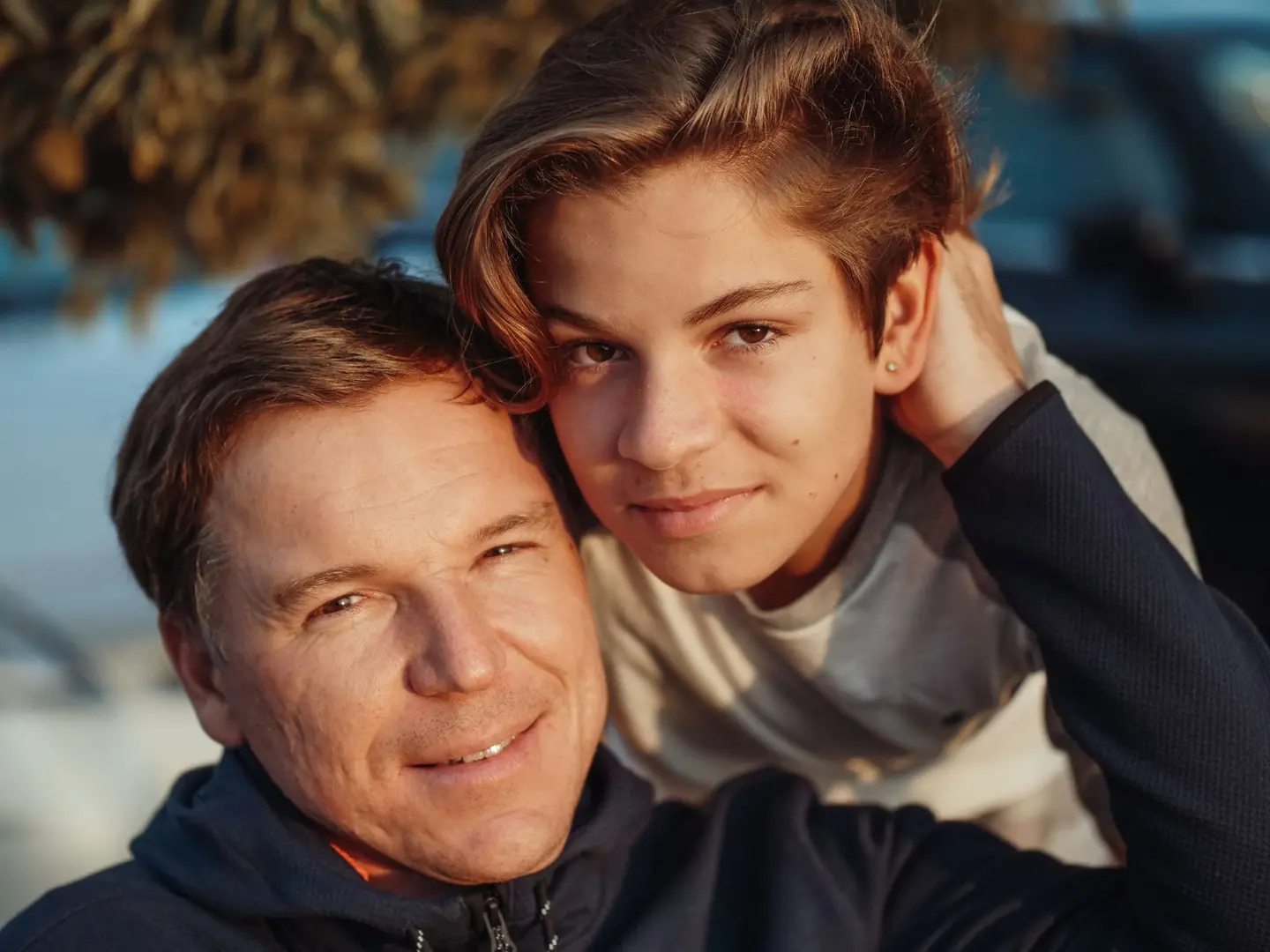 A father and his teenage son together outdoors