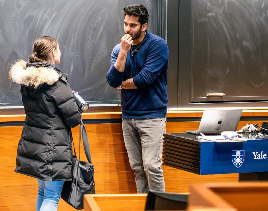 Hassan Akram in conversation with an attendee following an independent Yale student-club session.